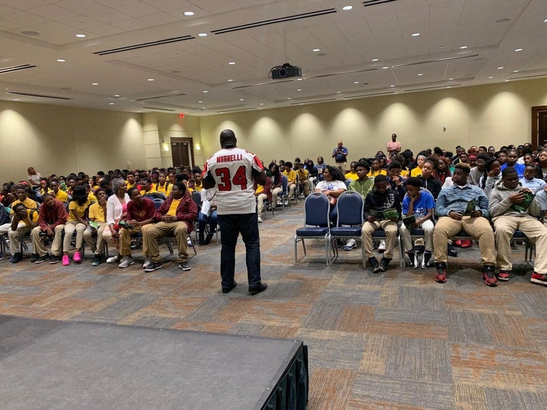Ovie Mughelli speaking to a packed auditorium