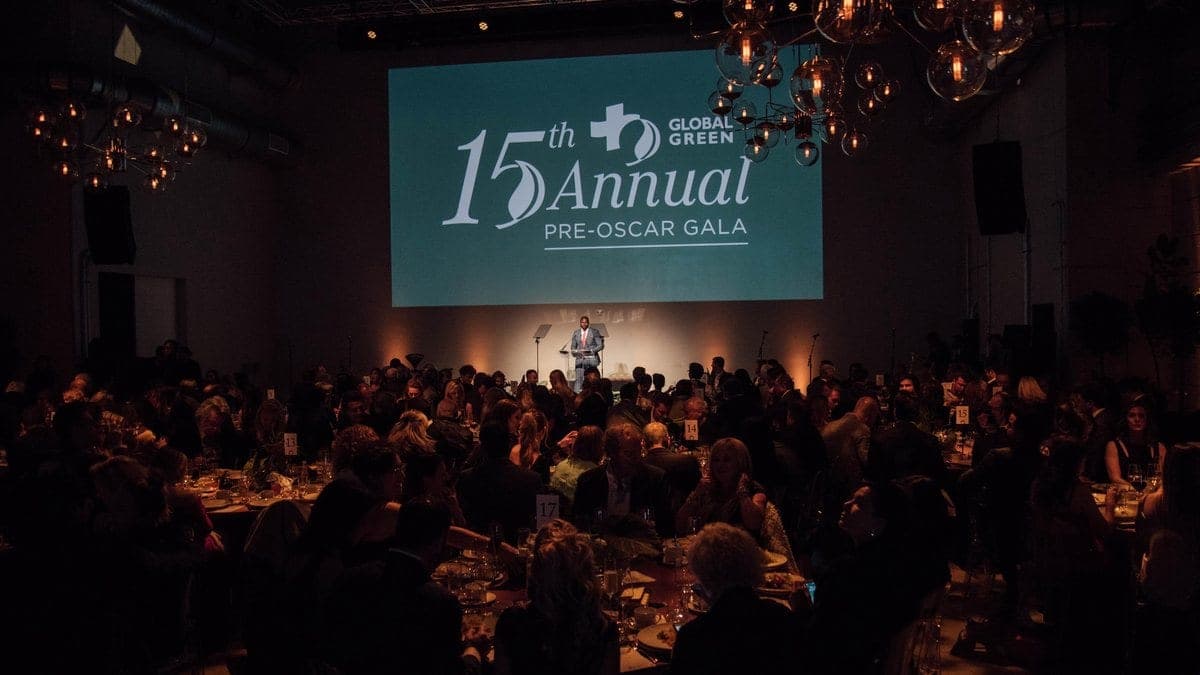 Ovie Mughelli speaking on stage at the Global Green Pre-Oscar Gala