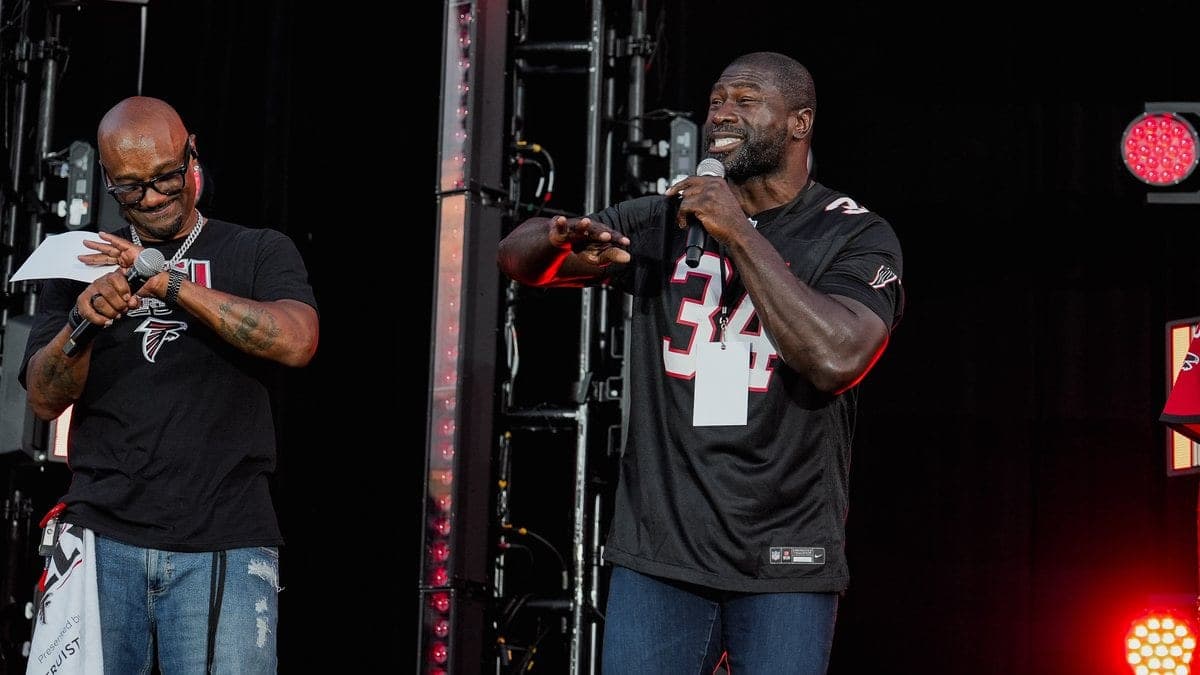 Ovie Mughelli in his #34 Falcons jersey speaking on stage