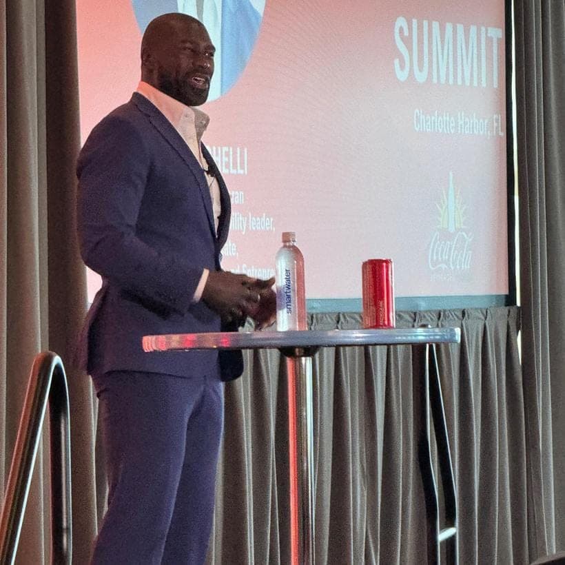 Ovie Mughelli delivering a keynote on stage