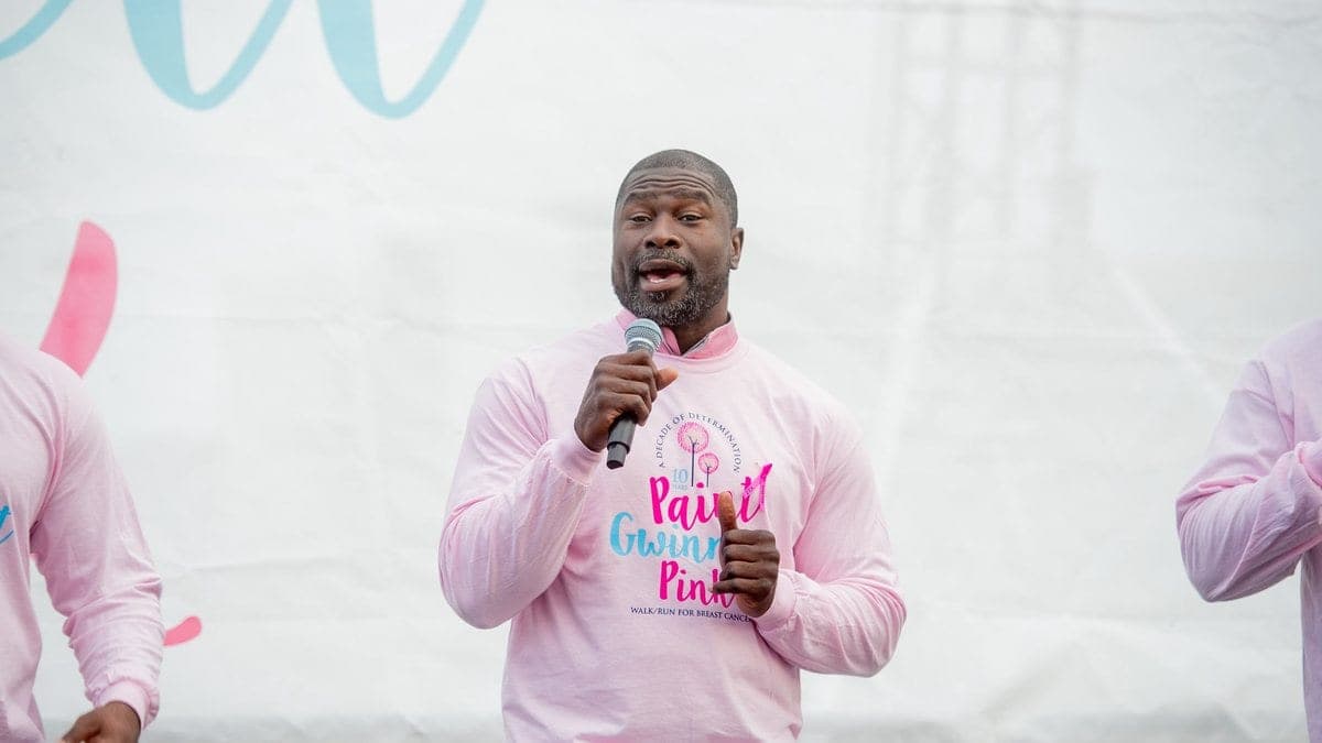 Ovie Mughelli addressing participants at a community health and environmental walk