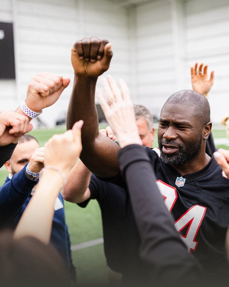 Ovie Mughelli greeting Atlanta Falcons fans along the sideline